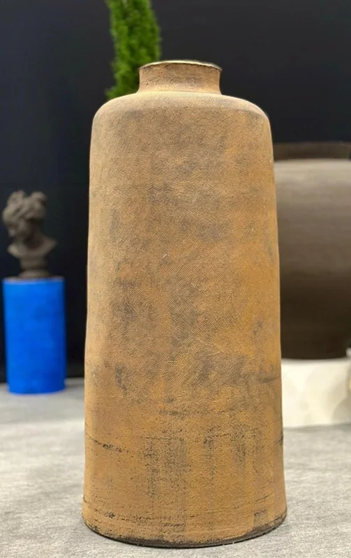 ALEXANDRE, a tall ochre cylindrical form