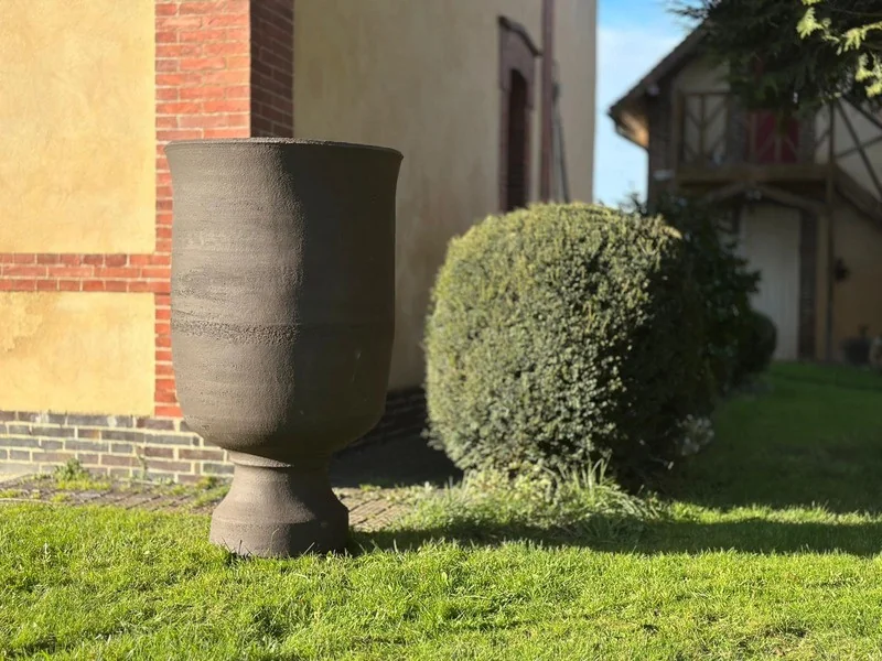 Raw KRATOS ceramic form in front of a Norman facade